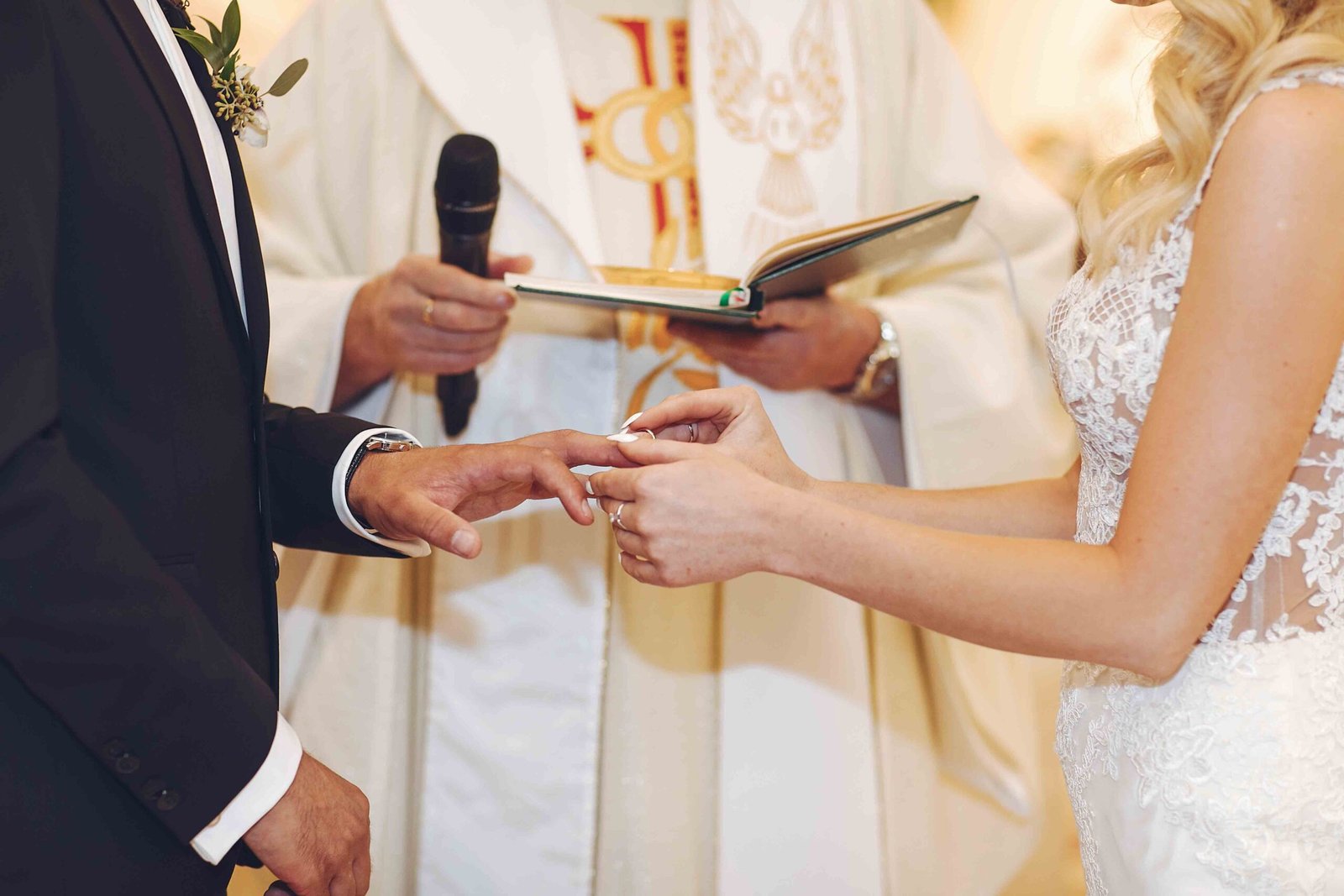 Beautiful bride in a long white dress. Handsome groom in a black suit. Couple in church